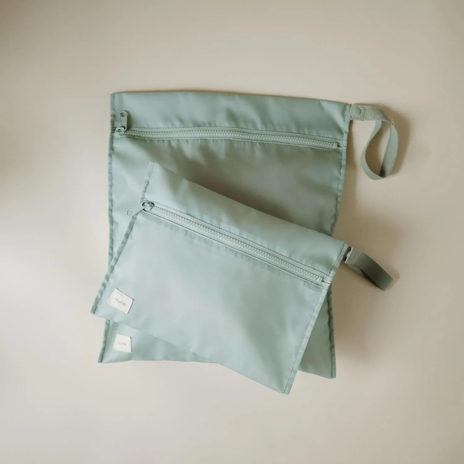 mushie Water Resistant Wet Bags | Large & Small Reusable Storage Bag for Baby Items and Travel | Zippered Pockets with Handle | Machine Washable, Set of 2 (Roman Green)